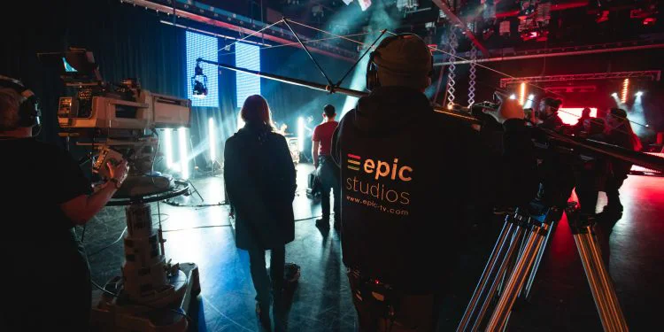 An Epic Studios crew member working behind the scenes at a live production